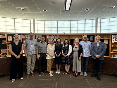 Dr. Kowalski stands in the center of a group photo with Board of Education members. 