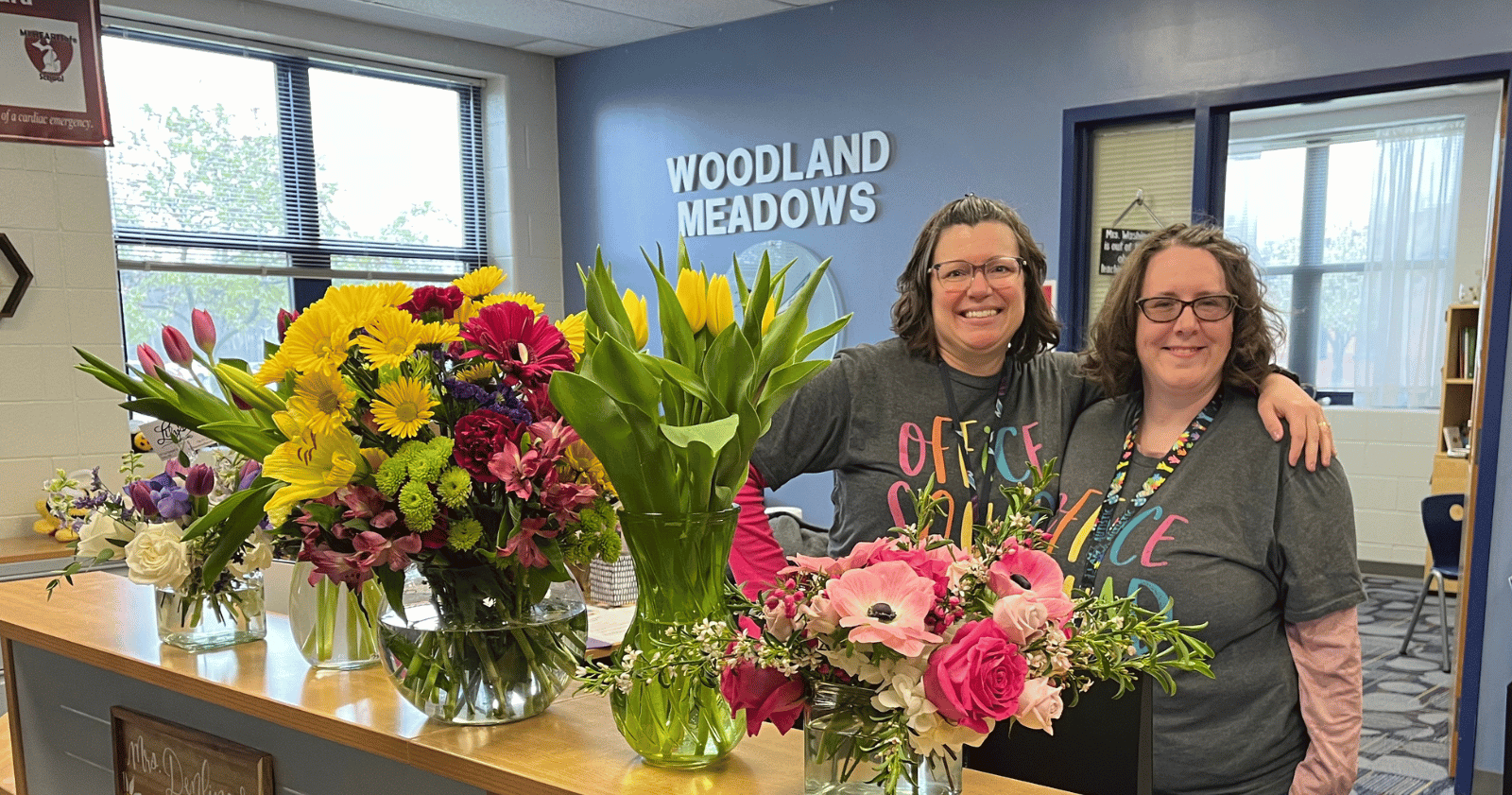 2 staff member with flowers