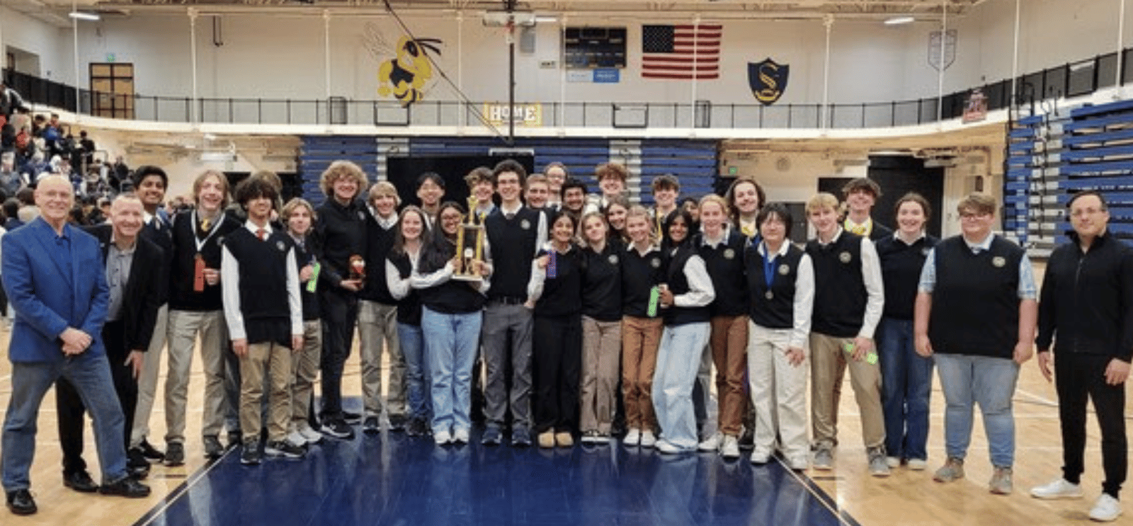 Science Olympiad Team with Coaches, Dr. Laatsch, and Michael McVey, standing in the gym