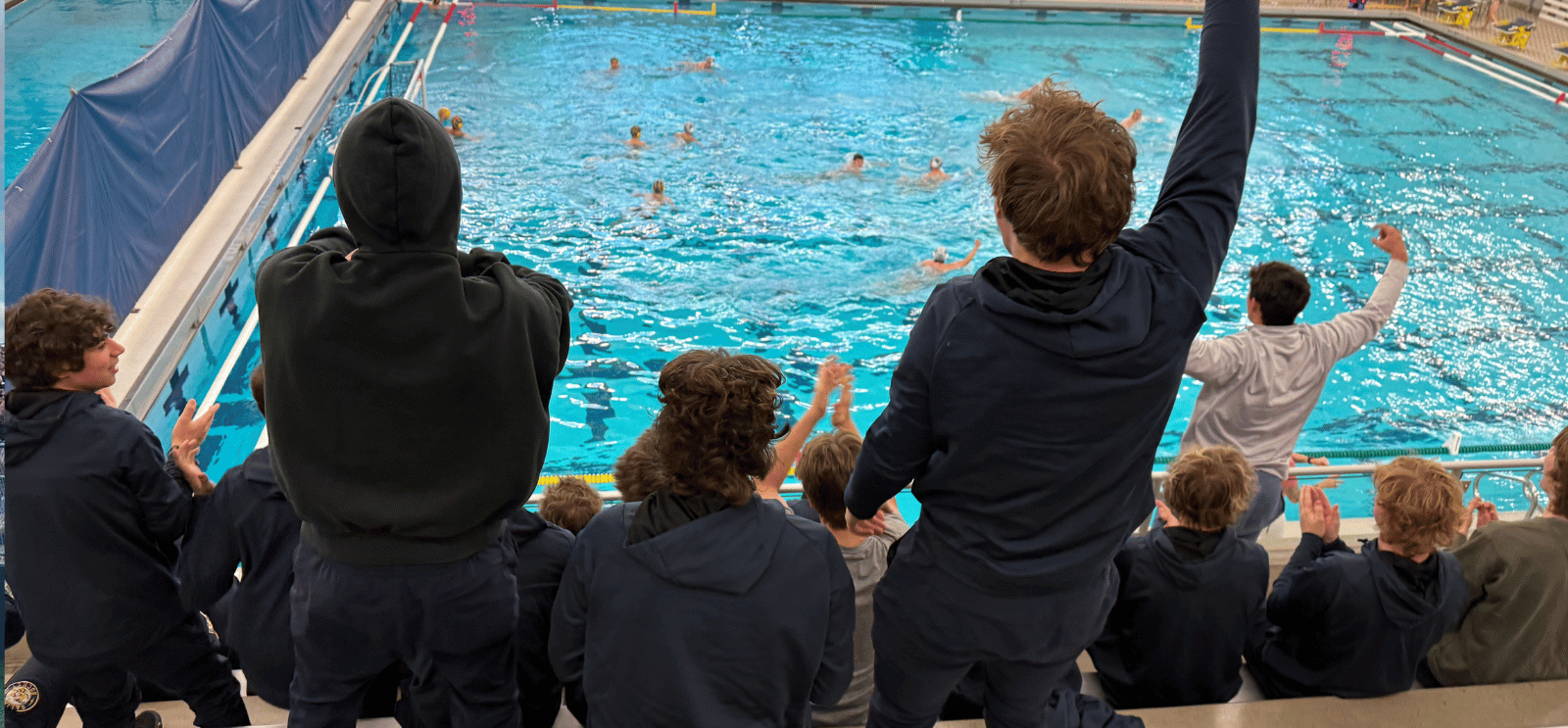 Fans cheering on the Water Polo team