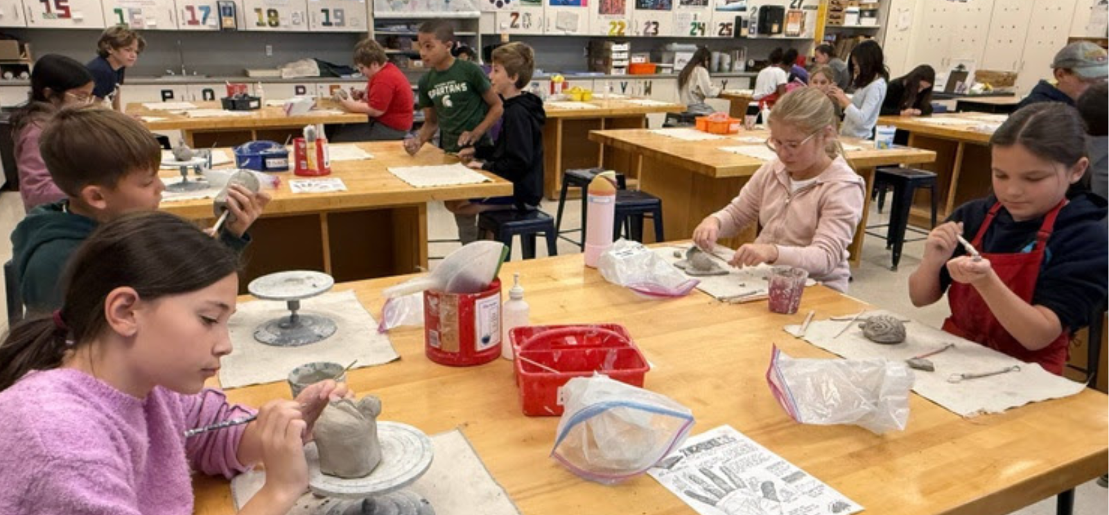 Student working on clay projects in art
