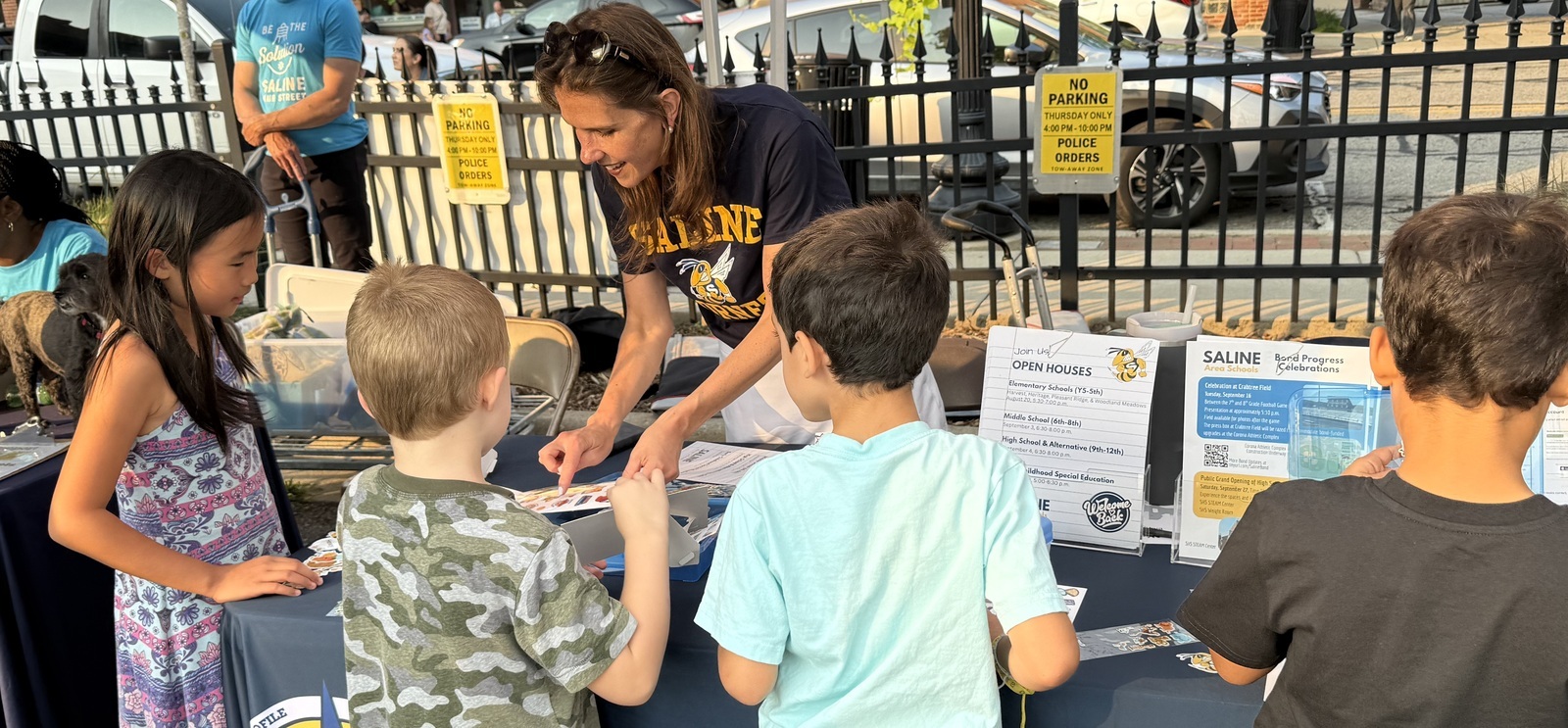 Superintendent showing students a card during summer event