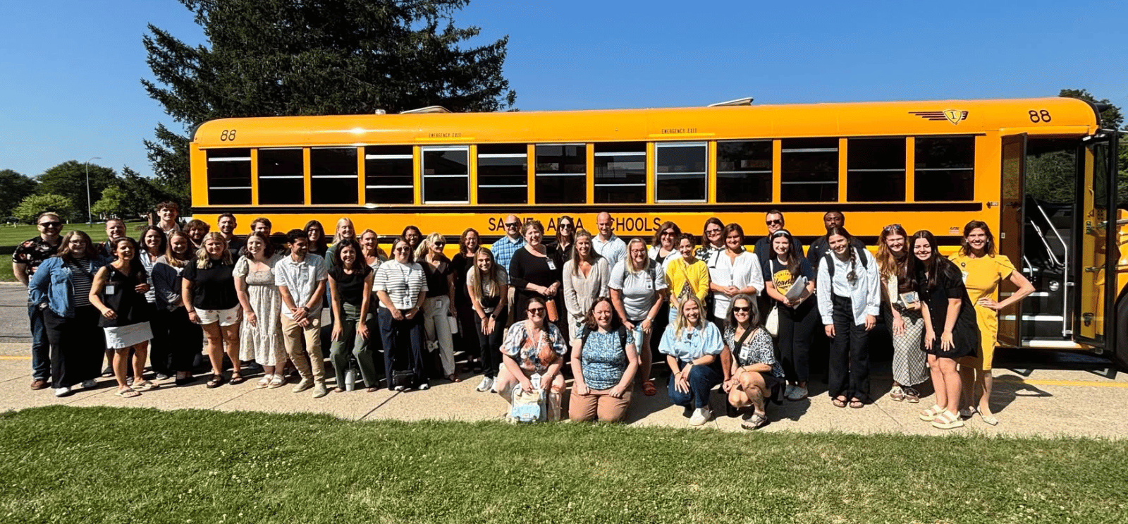 Staff standing in front of a bus