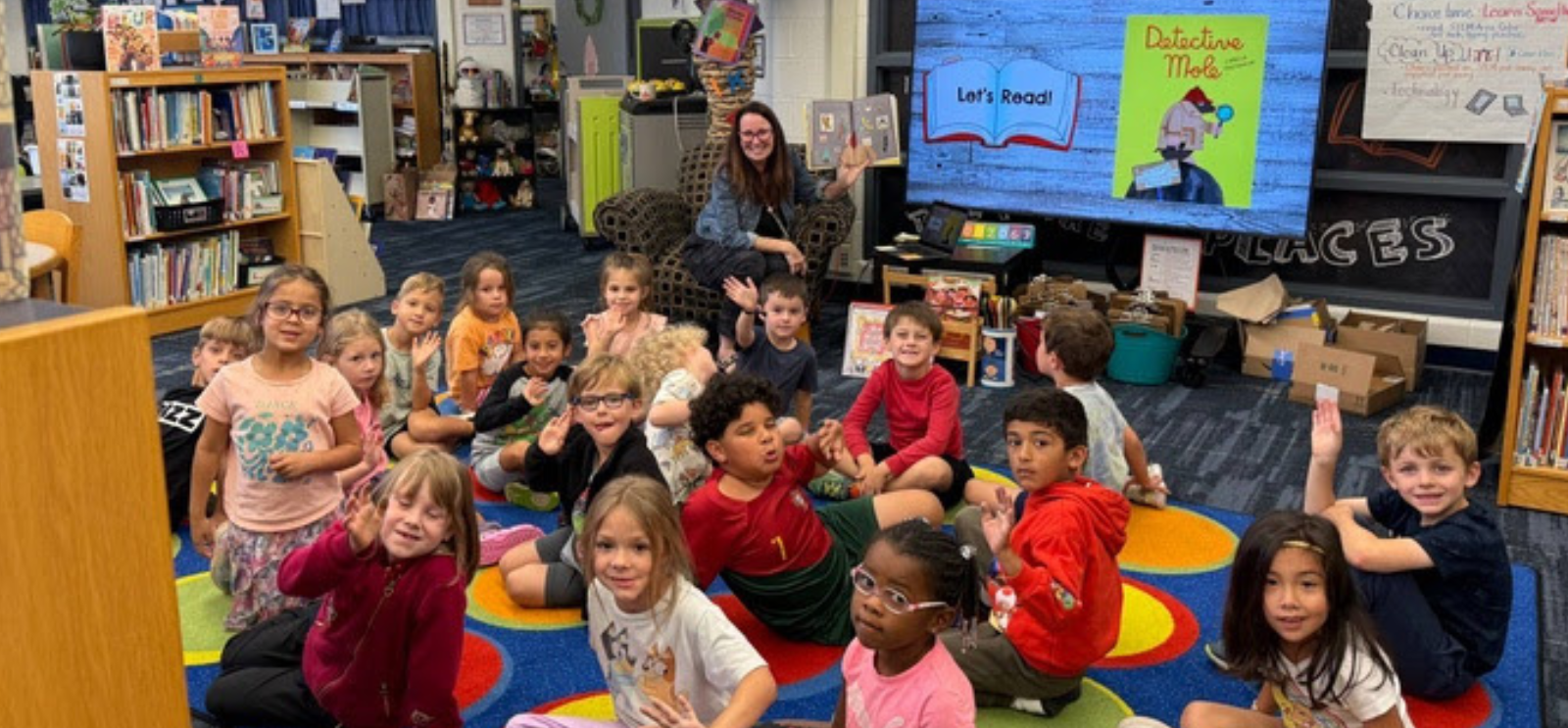 Pleasant Ridge students and teacher in Media Class, sitting on the floor