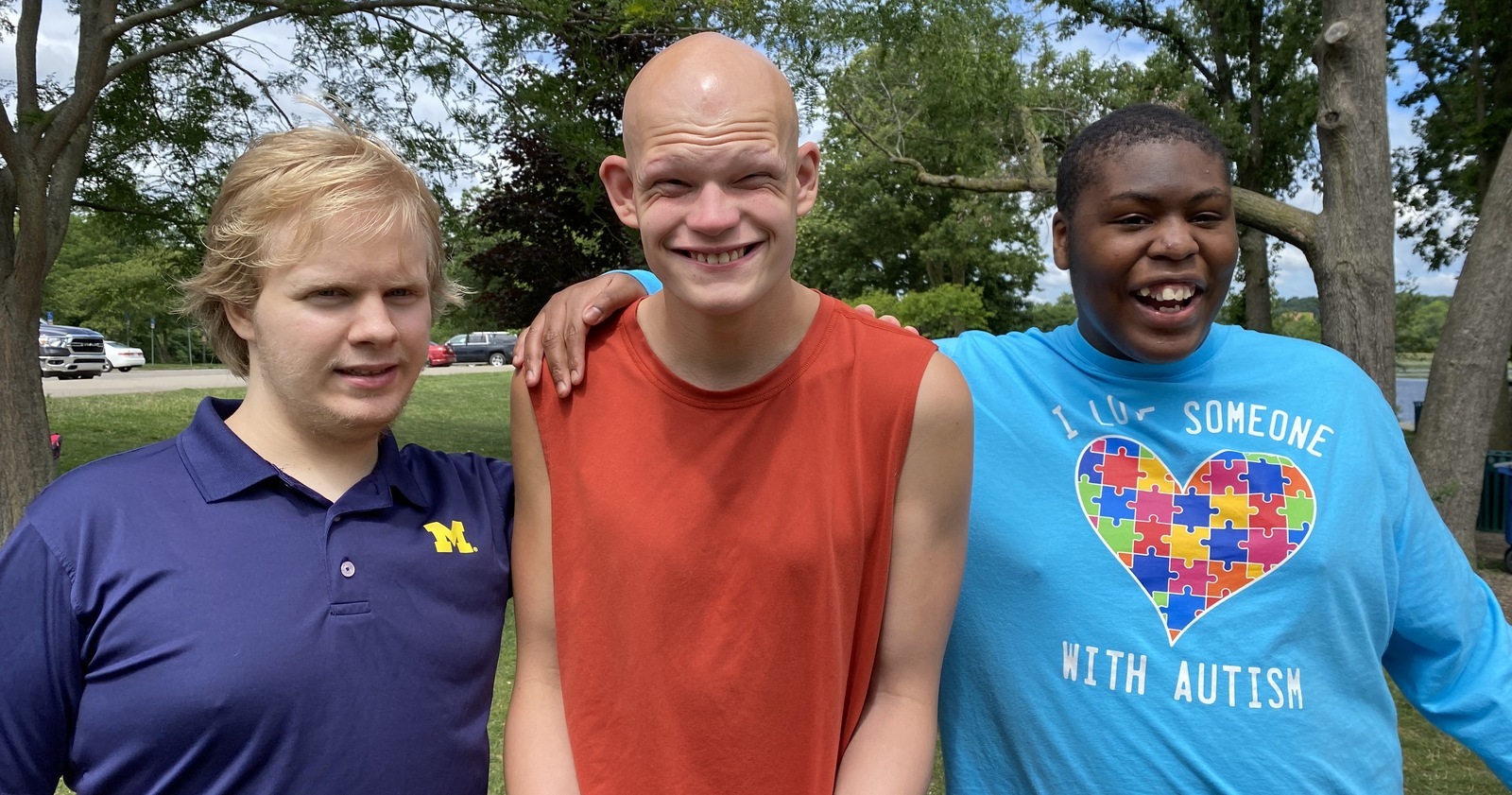 Three boys smiling at the park