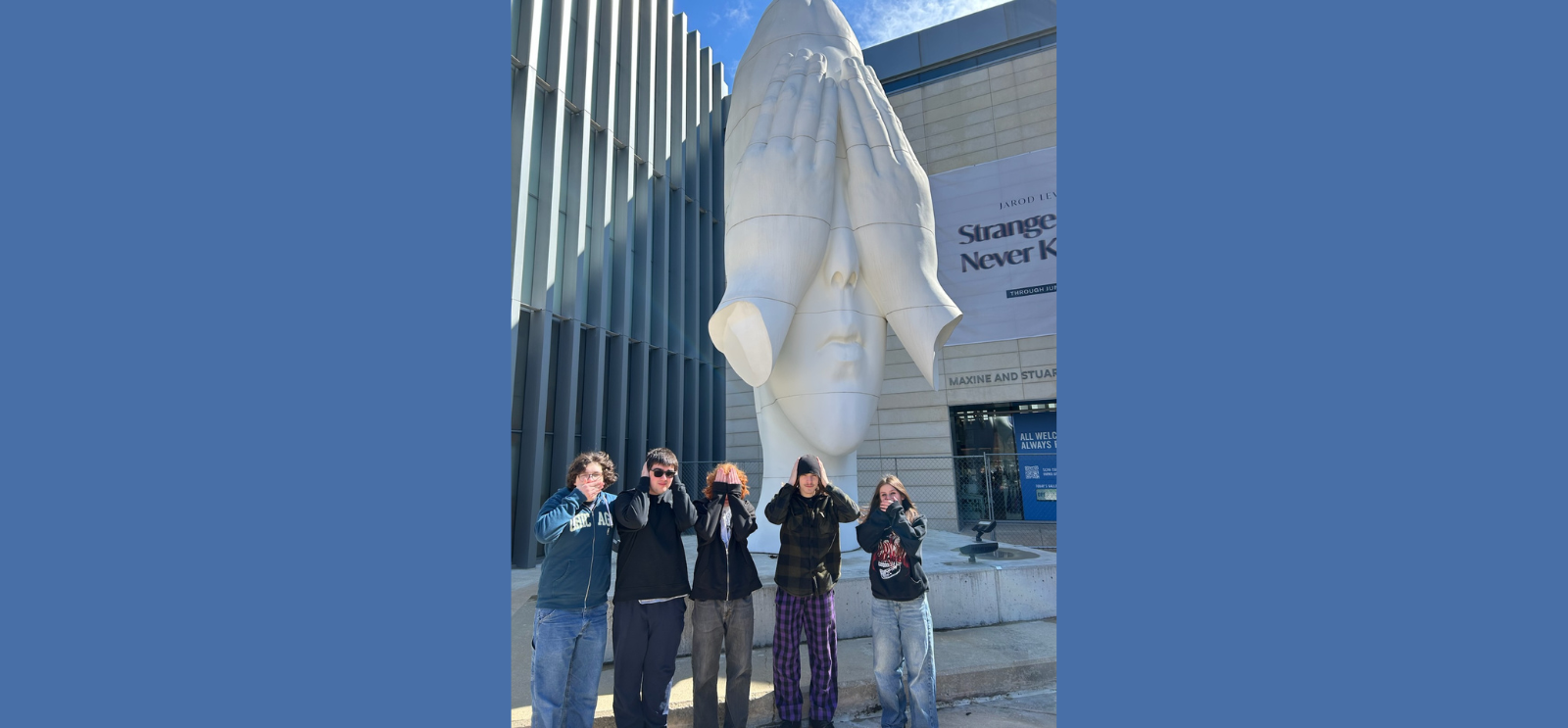 Students standing at a statue