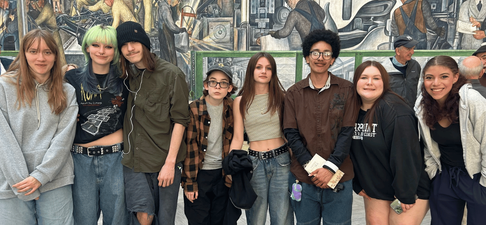 Students standing by a mural at the DIA